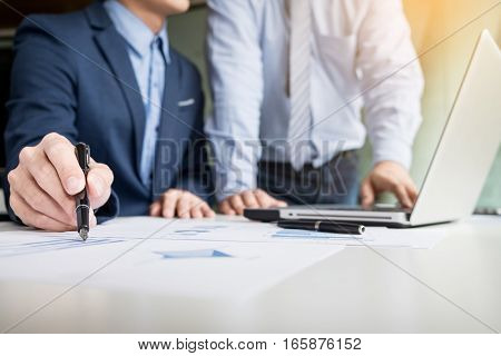 Team work process. young business managers crew working with new startup project. labtop on wood table typing keyboard texting message analyze graph plans.