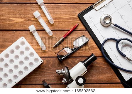 doctor workplace at wooden table with microscope in lab top view no one