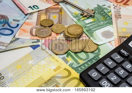 euro banknote and coins with house key