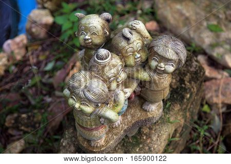 Stone figures in the grass in the park
