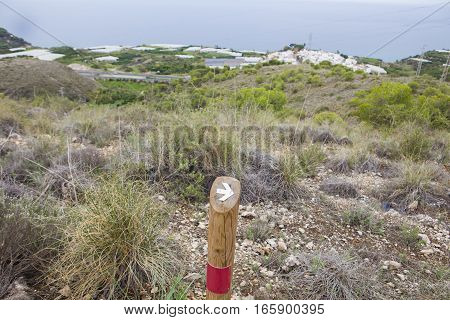Hiking sign at trekking path over Nerja Caves Mountain. Overlooking Town of Nerja Malaga Spain