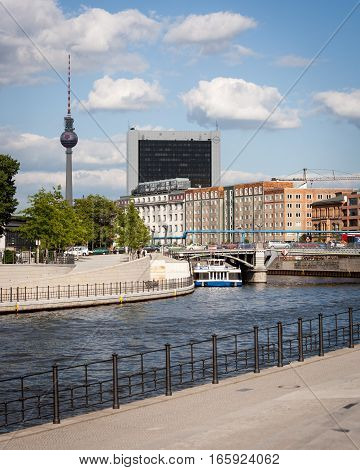 BERLIN GERMANY - JUNE 2 2006: A view east over the River Spree in Berlin Germany with the iconic television tower in Alexanderplatz and the Opel building towering over.