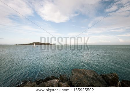 The Irish Sea from the coast near Malahide Ireland with some recreational yachts and a small island visible.