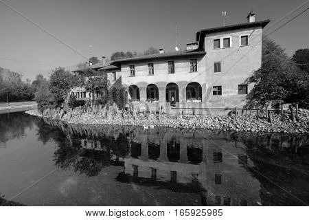 Country house along the Naviglio Grande of Turbigo (Milan Lombardy Italy) at fall with geese. Black and white
