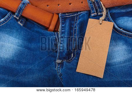 Denim trousers with a brown belt isolated on white background.