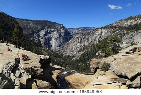 YOSEMITE NATIONAL PARK - SEP 22: Hikers take in the view of Yosemite Valley from the top of Nevada Falls on Sep 22, 2015 in Yosemite National Park. Nevada Falls is
located at the west end of Little Yosemite Valley.