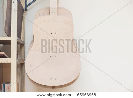 a row of classical unfinished guitar at workshop.