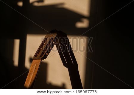 unfinished vulture guitar in sunlight at workshop.