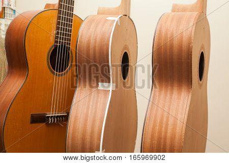 a row of classical unfinished guitar at workshop.