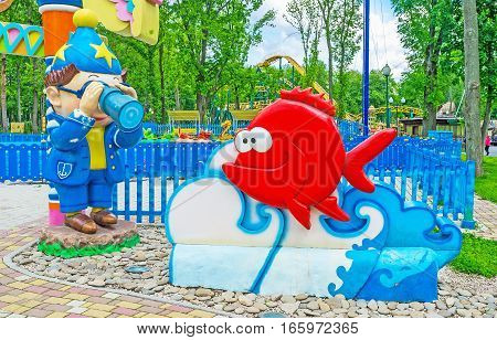 KHARKOV UKRAINE - MAY 20 2016: The character of Nikolay Nosov's story -Doonno (Znayka) with a spyglass discovers the sea creatures at the entrance to the children's yard Gorky Park on May 20 in Kharkov.