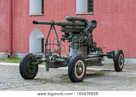 Anti-aircraft artillery gun on a wheeled platform standing in the courtyard of the Peter and Paul fortress in Saint-Petersburg.