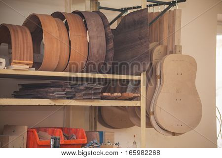 a row of classical unfinished guitar at workshop.