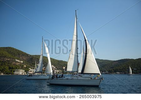 POROS, GREECE - OCT 10, 2018: Sailboat participate in sailing regatta 20th Ellada Autumn 2018 among Greek island group in the Aegean Sea, in Cyclades and Saronic Gulf.