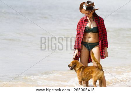 Woman Enjoy Outdoor With Dog And Hat On Beach At Bang Beot Beach, Chumphon Province Thailand