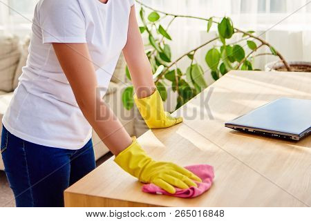 Cropped Image Of Woman In White Shirt And Yellow Protective Rubber Gloves Cleaning At Home And Wipin