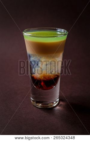Hiroshima Alcoholic Shot Glass With Absent, Sambuca, Irish Cream On Elegant Dark Brown Background.