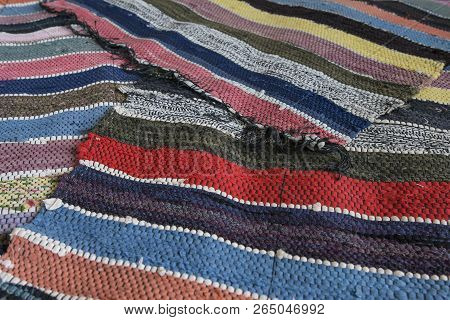 Traditional Rustic Striped Multi-colored Rug. Bright Textile. Village Eco Concept. Selective Focus