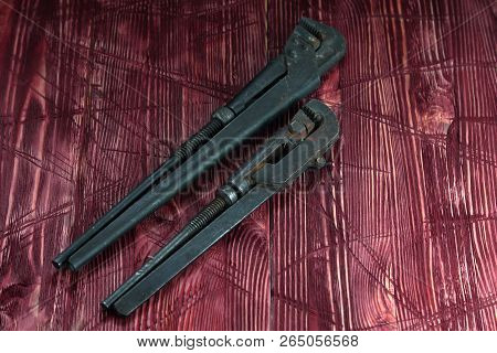 Tool On The Board Of Mahagany Background.