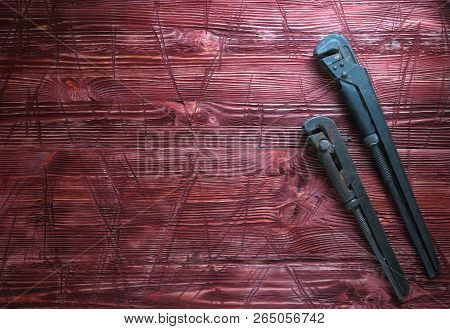 Tool On The Board Of Mahagany Background.