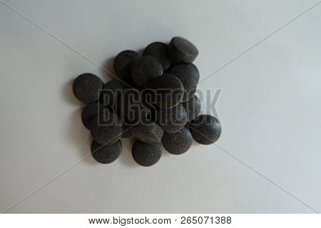 Group Of Round Black Pills Of Chelated Iron From Above