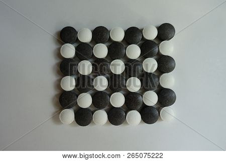 View Of Black And White Pills In Shape Of Checkerboard From Above