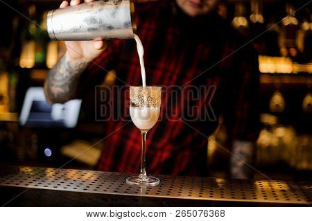 Bartender Pouring Sweet And Tasty Brandy Crusta Cocktail Into A Sweet Wine Glass On The Bar Counter