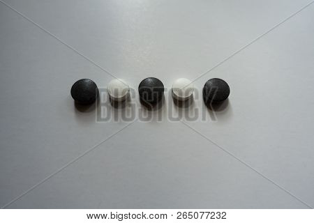 Black And White Round Pills In A Row