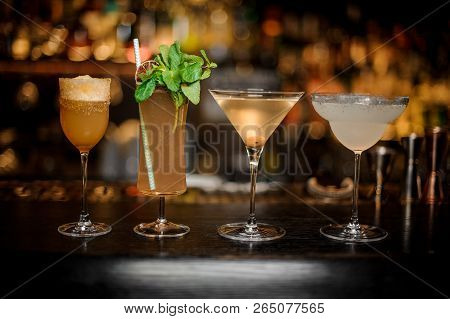 Set Of Classic Cocktails: Dirty Martini, Sherry Cobbler, Brandy Crusta And Margarita Arranged On The