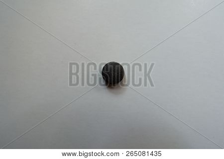 View Of Round Black Pill Of Chelated Iron From Above