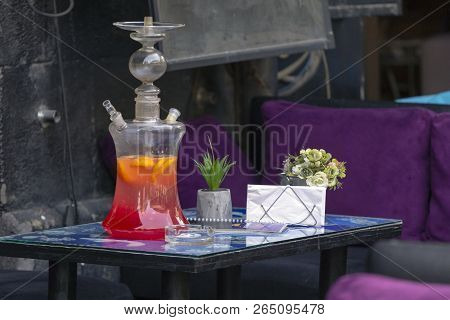 Glass Hookah With Red Juice On Dark Background