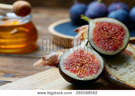 Cut Figs On A Wooden Board Watered With Honey. Rustic Style.