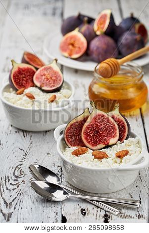 Cottage Cheese With Figs, Honey And Almonds In A White Bowl On A Light Background. Concept: Healthy