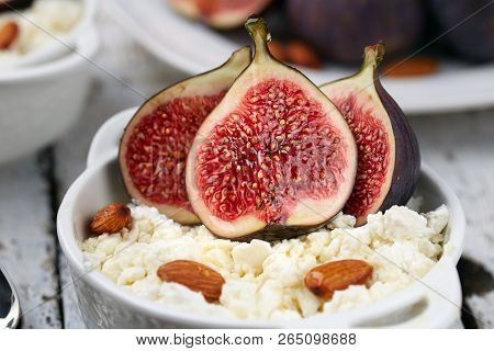 Cottage Cheese With Figs And Almonds In A White Bowl On A Light Background. Concept: Healthy Breakfa