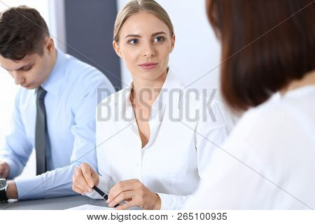 Group Of Business People Or Lawyers Discussing  Terms Of Transaction In Office. Meeting And Teamwork