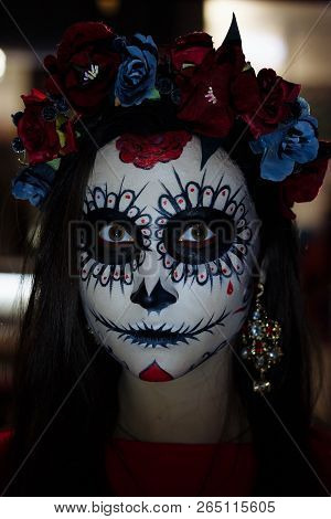 A Girl With A Painted Face Of A Skeleton, A Dead Zombie, In The City During The Day. Day Of All Soul