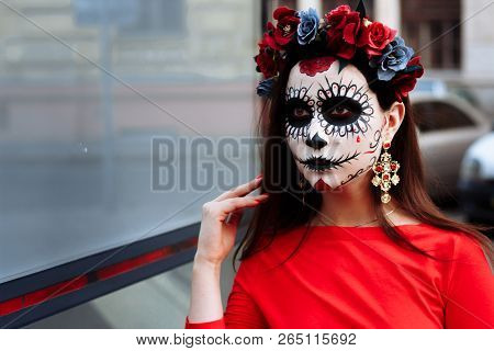 A Girl With A Painted Face Of A Skeleton, A Dead Zombie, In The City During The Day. Day Of All Soul