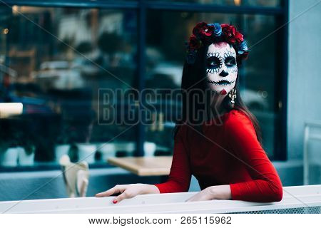 A Girl With A Painted Face Of A Skeleton, A Dead Zombie, In The City During The Day. Day Of All Soul