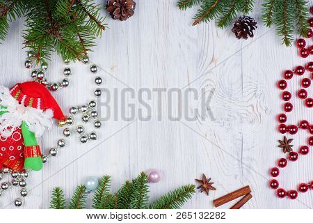 New Years Frame With Santa Clauss Toy, Shiny Beads And Decorated With Fir Branches