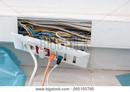 Plactic  Cable Channel While  Repairing  With Electrical Outlets On  Where Two Ethernet Cables And O
