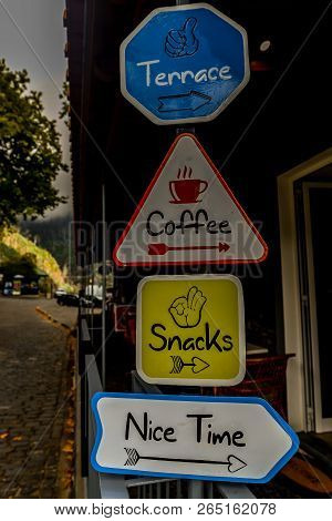 Cafe Signs Next To The Monte Palce Trpical Garden