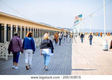 Deauville, France - September 06, 2017: Planches Promenade With People Walking Near The Locker Rooms