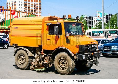 Ufa, Russia - May 12, 2010: Watering And Cleaning Machine Unimog U1400 In The City Street.