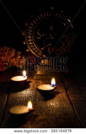 Diwali lights oil candles with Shiva Nataraja in the background for Maha Shivaratri,  India
