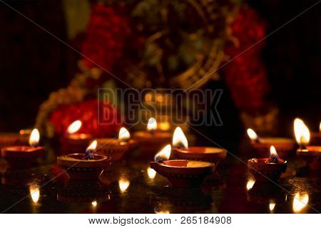 Diwali lights oil candles with Shiva Nataraja in the background for Maha Shivaratri,  India
