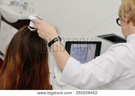 Doctor Examines The Hairy Part Of The Patient's Head