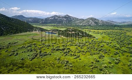Aerial View Of The Landscape Of Lake Skadar In The Mountain And The Island With Monastery On A Beaut