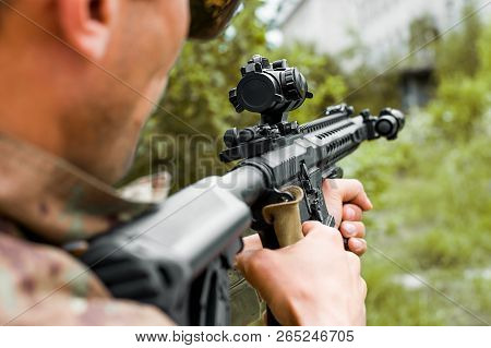 Military Man With Automatic Rifle And Rifle Scope