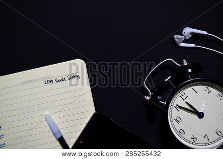 Notebook, Smartphone, Earphone And Color Pen With Selective Focus 2019 Goals Setting Text In Black B