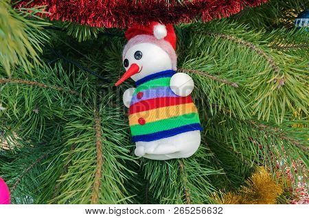 Christmas Decoration In The Form Of A Funny Snowman Hanging On A Christmas Tree
