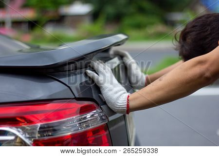 Mechanic Man Pushing A Broken Car Down The Road Side View.